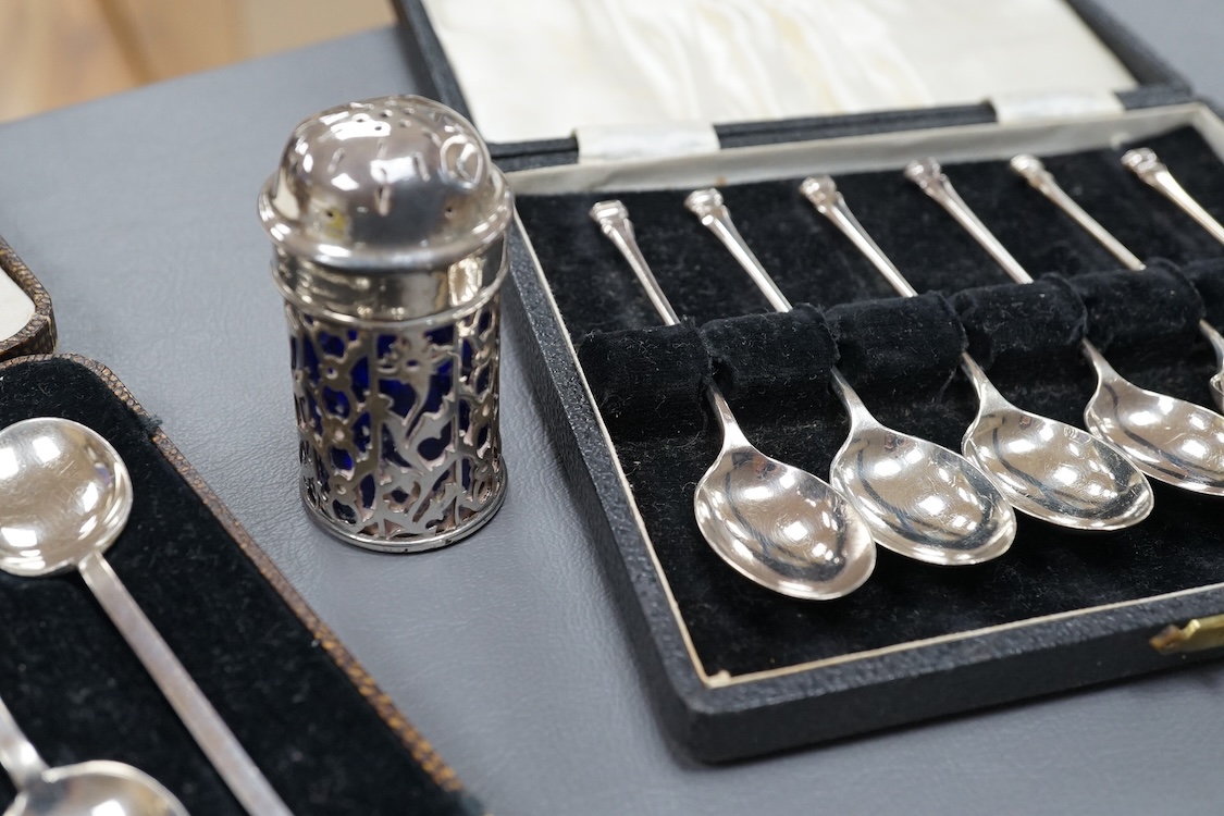 Four assorted silver napkin rings, two cased sets of six silver spoons, four silver condiments including a pair, a small group of sundry flatware, a silver wine label and a plated napkin ring.